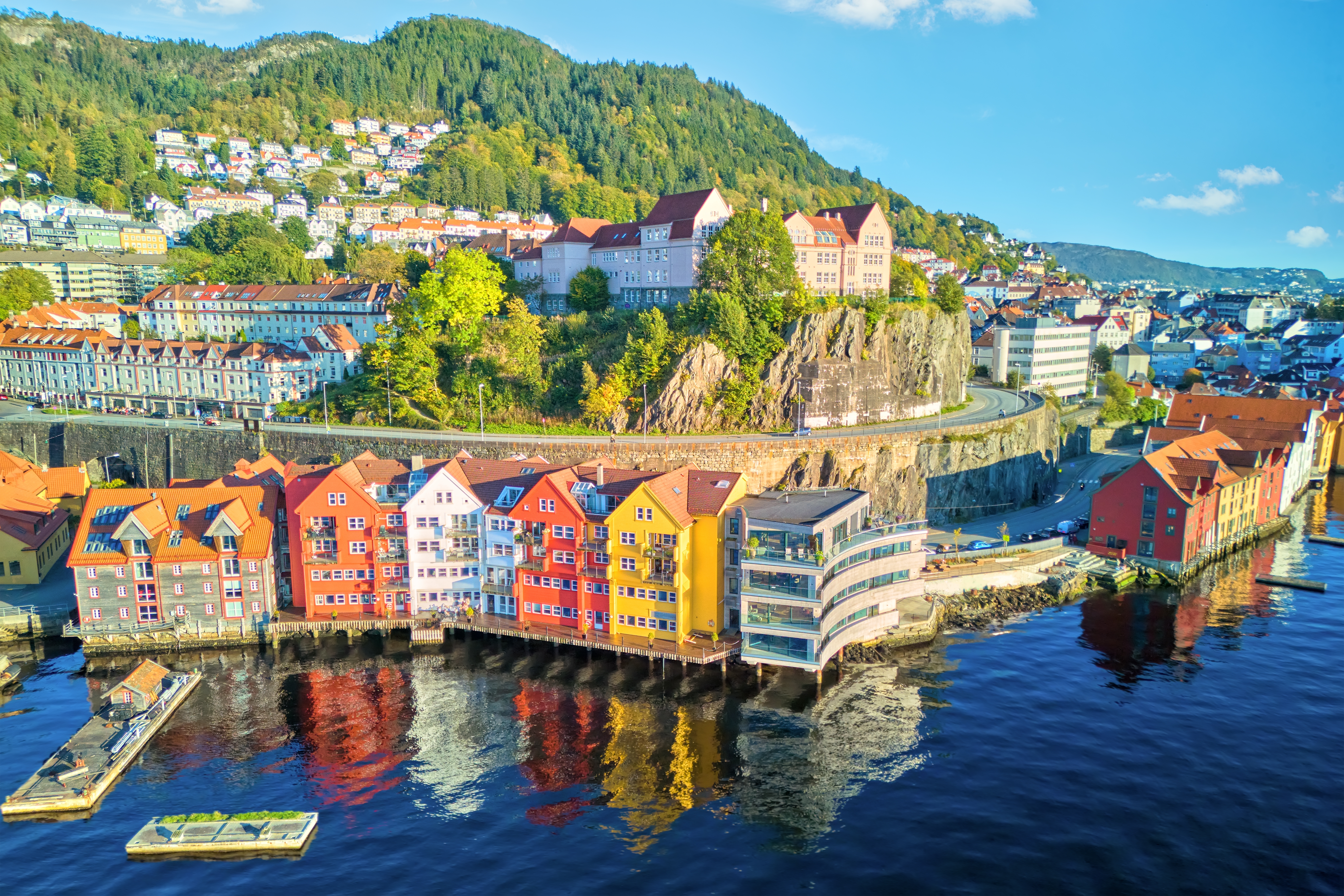 norwegian fjords lined with colourful buildings and blue skies